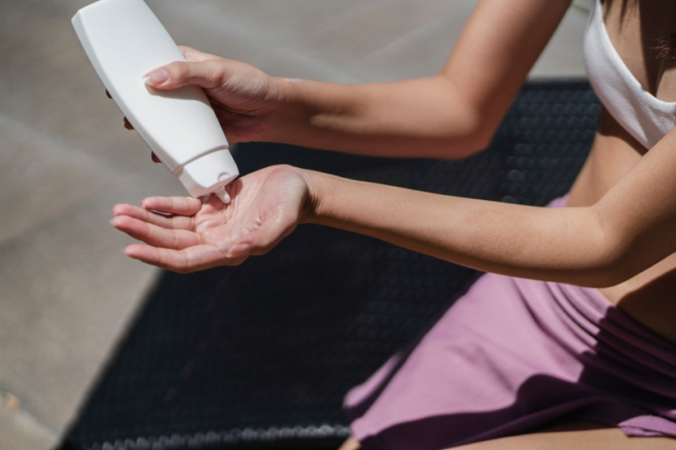Close-up of a woman putting on lotion