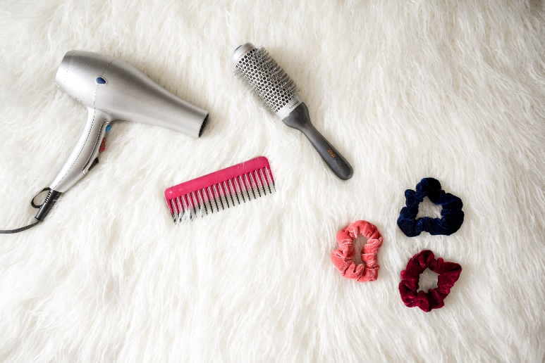 A blow dryer, a roller, combs, and scrunchies.