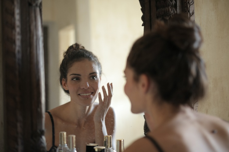 A person smiling in a mirror reflection
