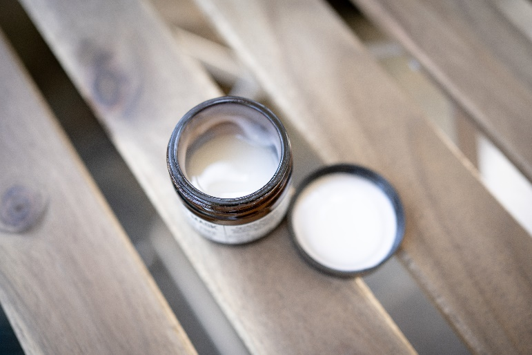 A small, open tub of a skincare product.