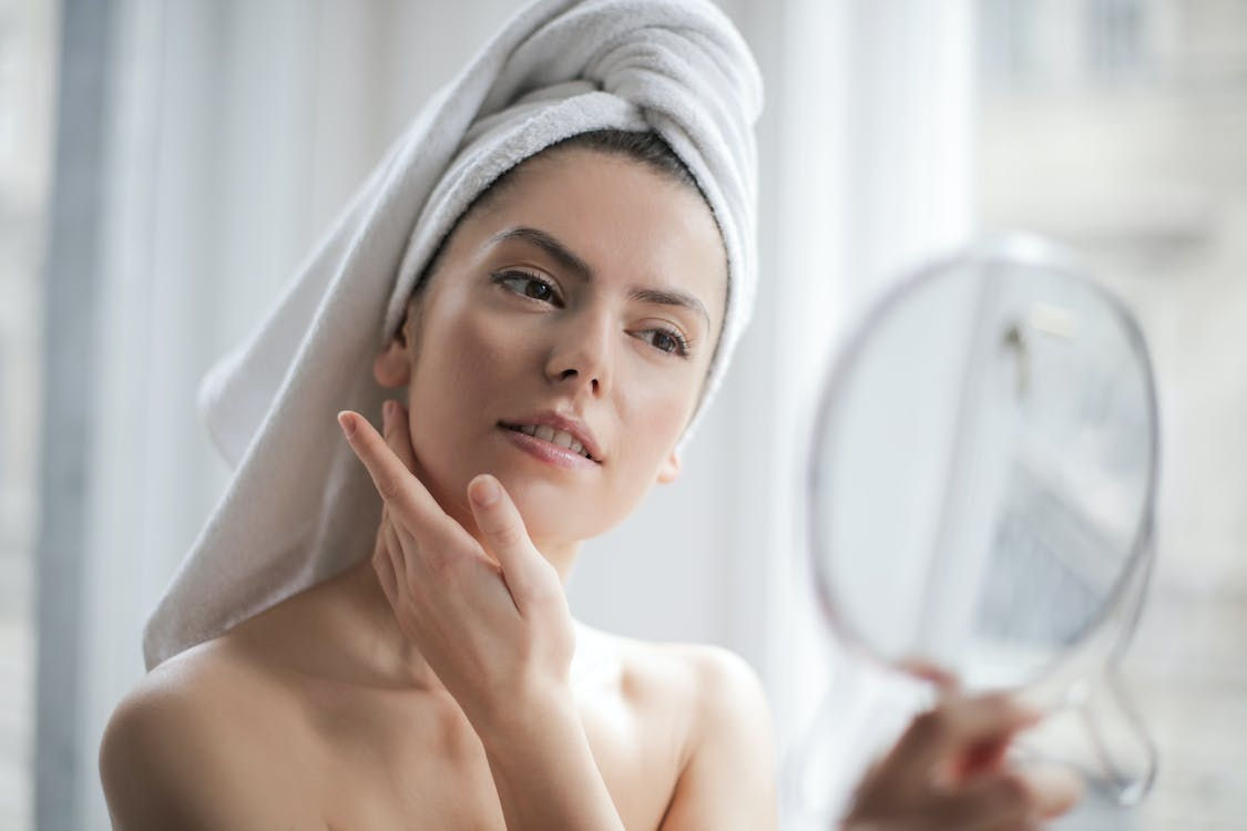 a woman looking in a mirror